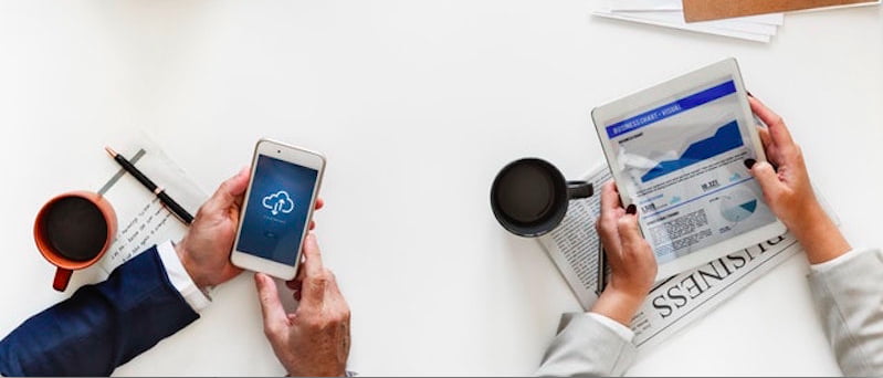 hands-holding-phone-tablet-desk-paper